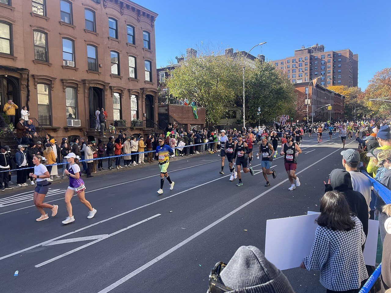 Runners run in Clinton Hill during the 2024 Marathon